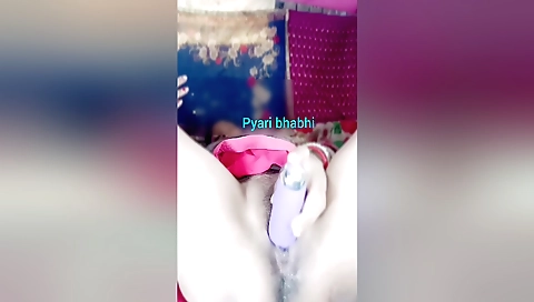 Indian girl is masturbating on her bed with a dildo