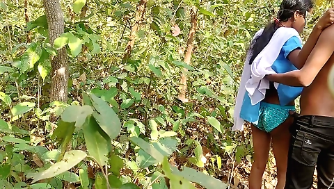 Indian girl is riding a bike in the jungle outdoors